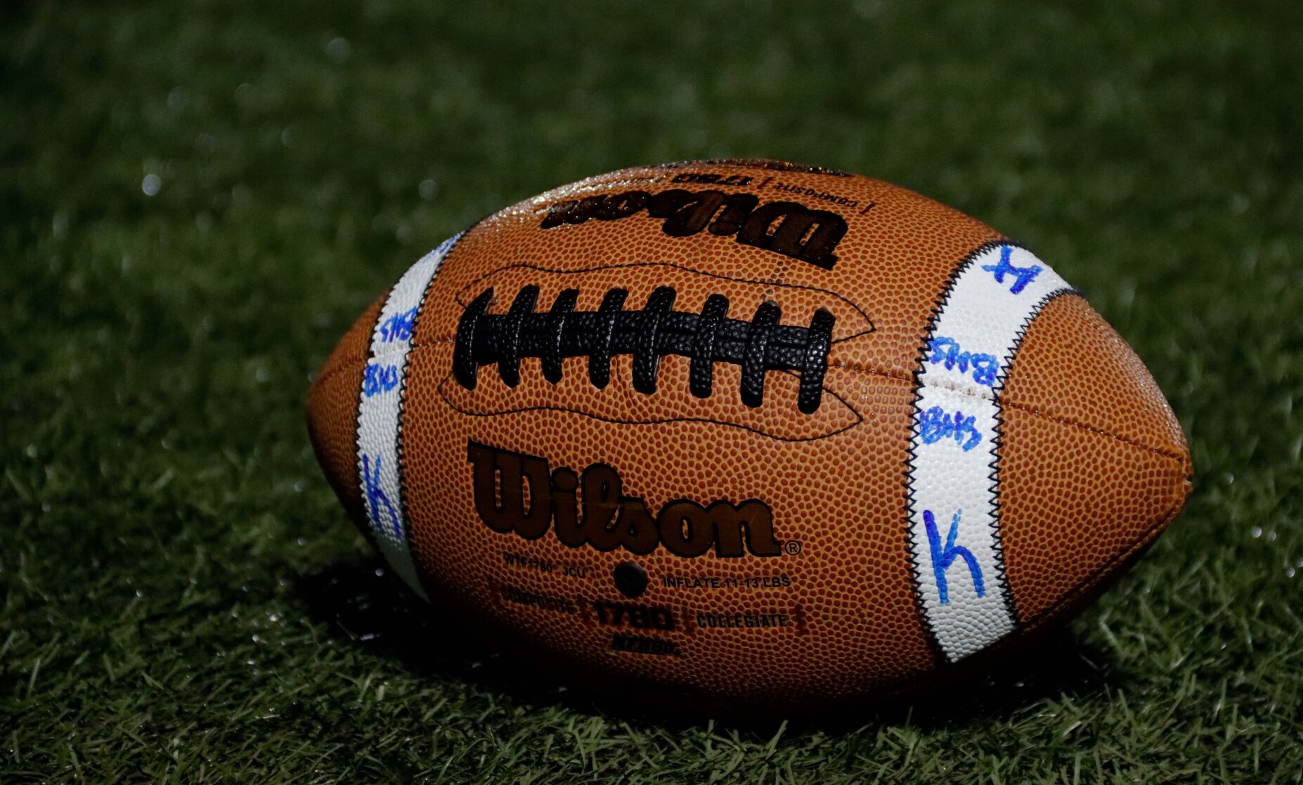 A wet ball lies on the sideline for Battle kickers to practice